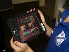 an image of student using a portable device 